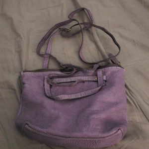 This is an adorable dark lavendar leather bag